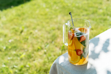 Decanter with iced summer lemonade close up