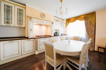 The interior of a large and spacious kitchen-living room in a classic style. 