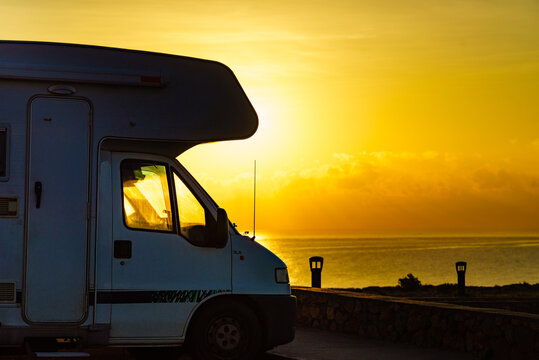 Caravan on coast at sunrise
