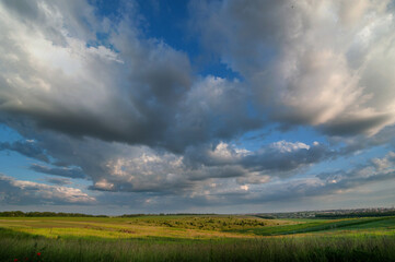 Fototapeta na wymiar fields and evening sky with clouds