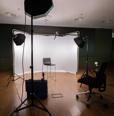 Filming set with lights, cameras and white background.