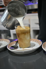 Serving a coffee with milk