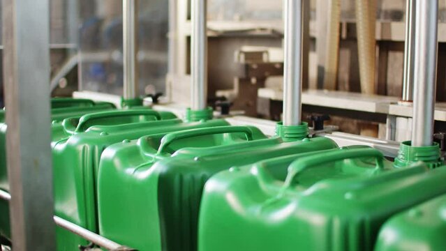 Pouring Liquid into Canisters Micro Fertilizer Production Factory