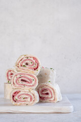 Ham and cream cheese rolled up in a flour tortilla