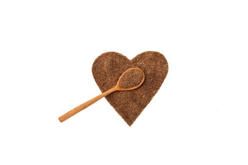 Milk Thistle Oil cake or Silybum marianum extract in heart shape and wooden spoon on white background. Herbal superfood for aiding liver function. Strong antioxidant