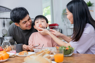 Happy Asian family, young boy eating healthy food together