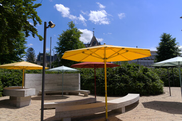 Close-up of yellow sunshade at park at City of Zürich on a blue cloudy spring day. Photo taken May 30th, 2022, Zurich, Switzerland.