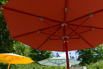 Colorful sunshade at park at City of Zürich on a blue cloudy spring day. Photo taken May 30th, 2022, Zurich, Switzerland. - obrazy, fototapety, plakaty