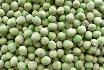 Frozen green peas texture background. 