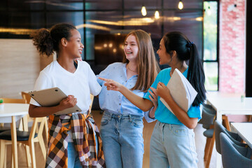 Group of teenager student walking to leaning in library of school. University Library education and...