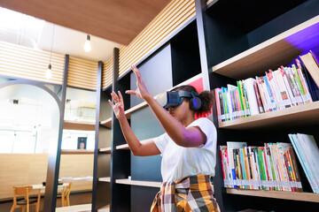 VR headset library. Young teen girl student training and learning with VR virtual teality headset in school library.