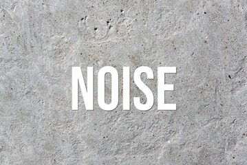 NOISE - word on concrete background. Cement floor, wall.