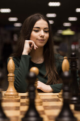 beautiful girl playing chess - 510599031