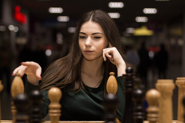 beautiful girl playing chess - 510599035