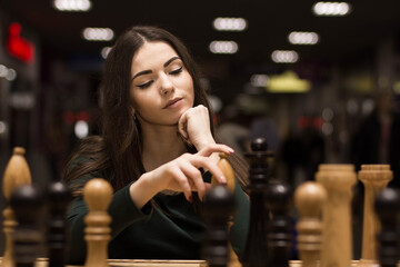 beautiful girl playing chess - 510599036