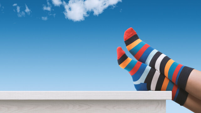 Creative Person With Multicolor Sock Relaxing With Feet Up
