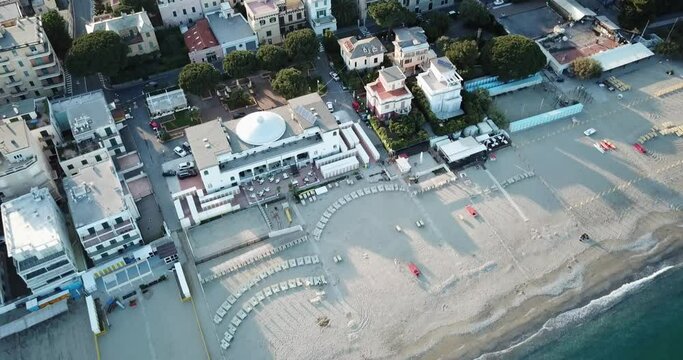Top view of an italian sandy beach with an hotel and buildings. aerial drone shot