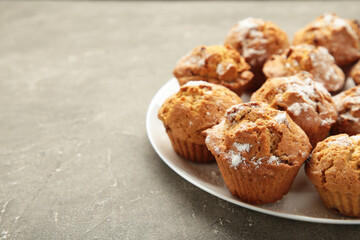 Vanilla muffins. Sweet cupcakes on white plate. Top view.