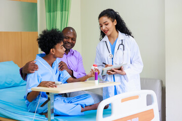 Obraz premium black woman doctor and man patient. black female doctor talking consulting and checkup by stethoscope with patient Hospital Healthcare and medicine concept.