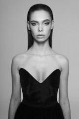 Beautiful woman pose in studio. Art portrait of a model in a black dress - 510603662