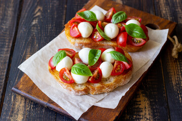 Bruschetta with mozzarella, tomatoes and basil. Vegetarian food. Healthy eating.