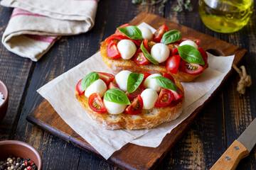 Bruschetta with mozzarella, tomatoes and basil. Vegetarian food. Healthy eating.