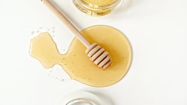Rotation of the Composition with Fresh Honey on a White Background, top view. Healthy Food Concept. High quality 4k footage