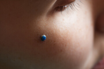 Photo of piercing in the girl, crystal in the middle of clavicles. Microdermal.