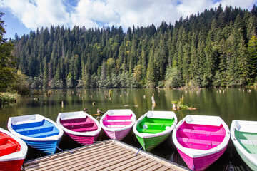 colorful boats in calm mountain lake