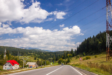 white clouds over mountain road view