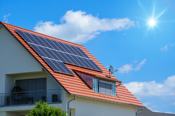 home with solar energy green plants and sunny blue sky