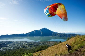 Paraglider starting from Batur volcano. Bali, Indonesia