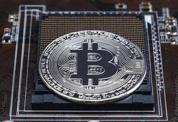 Fototapeta na wymiar Cryptocurrency bitcoin silver coins on circuit board