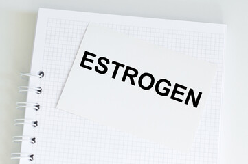 Medical concept, the text on the Estrogen card on the background of a notepad on the table