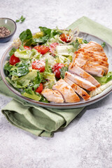 Fototapeta na wymiar Green salad with grilled chicken breast