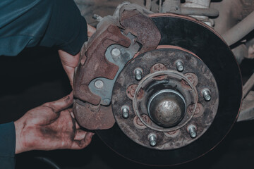 The mechanic is checking the engine.