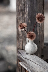 Autumn background. Still life with old dried flowers on a wooden fence. Flowers and garden decor