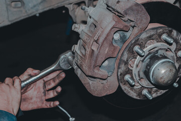 The mechanic is checking the engine.