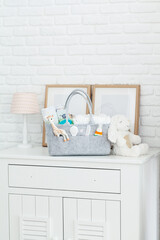 Mothers bag with toy and accessories on white background
