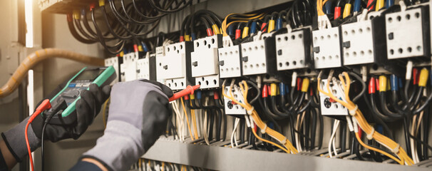 Electricity and electrical maintenance service, Engineer hand holding AC multimeter checking...