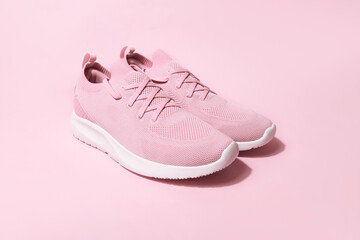 Pink pastel color sneakers on background - obrazy, fototapety, plakaty