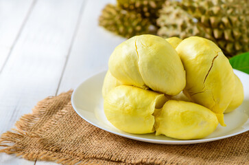 Fresh durian (monthong) on white dish and white wood background,
