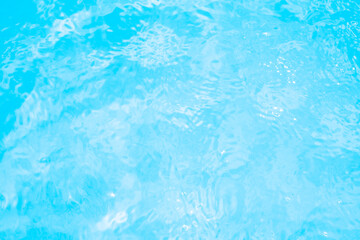 Blurred transparent blue colored clear calm water surface texture with splashes and bubbles. Trendy abstract nature background. Water waves in sunlight. water background
