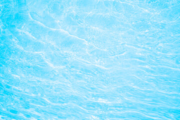Blurred transparent blue colored clear calm water surface texture with splashes and bubbles. Trendy abstract nature background. Water waves in sunlight. water background