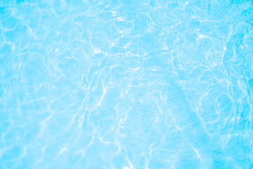 Blurred transparent blue colored clear calm water surface texture with splashes and bubbles. Trendy abstract nature background. Water waves in sunlight. water background