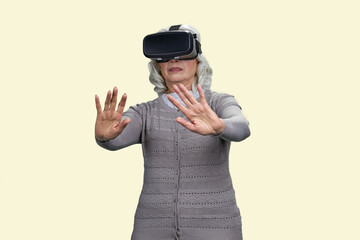Old lady shocked experiencing virtual reality headset. Isolated on white background.
