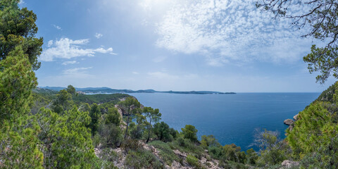 Fototapeta na wymiar Viewpoint of the Majorca coastline with the view on the sea, cliffs, forest and summer sky, Mallorca, Balearic islands, Spain