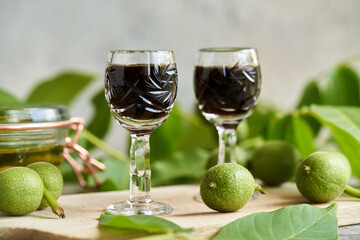 Homemade nut liqueur with fresh green unripe walnuts