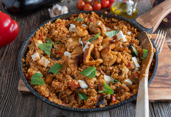Eggplant rice pan with vegetables, real feta cheese and chicken meat
