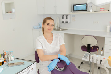 Portrait of female dentist .She standing in her dentist office